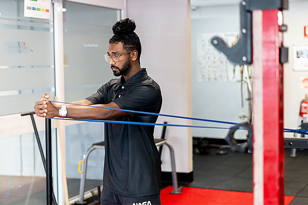 Exercise physiologist using bands for strength training